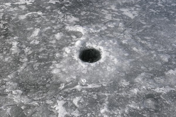 Winter riverscape, fishing hole, Saint Lawrence River, Province of Quebec, Canada, North America