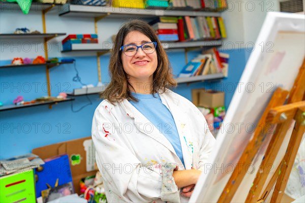 Portrait of a happy and satisfied disabled woman in the painting class