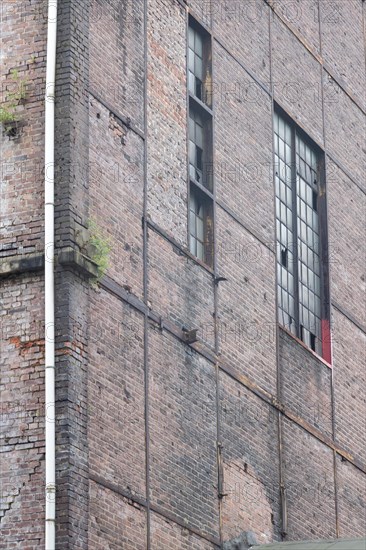 Detailed view of a dilapidated industrial building with patina on the red bricks