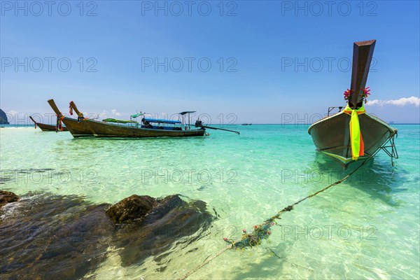 Longtail boat, fishing boat, wooden boat, boat, decorated, tradition, traditional, faith, cloth, colourful, bay, sea, ocean, Andaman Sea, tropics, tropical, island, water, beach, beach holiday, Caribbean, environment, clear, clean, peaceful, picturesque, sea level, climate, travel, tourism, paradisiacal, beach holiday, sun, sunny, holiday, dream trip, holiday paradise, paradise, coastal landscape, nature, idyllic, turquoise, Siam, exotic, travel photo, sandy beach, seascape, Phi Phi Island, Thailand, Asia