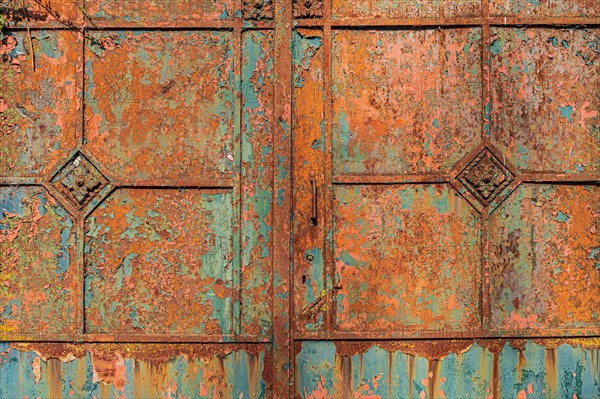 Old metallic surface with weathered rusty texture in blue-green and orange tones, Mettmann, North Rhine-Westphalia