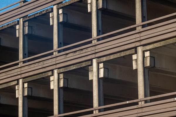 Multi-level car park with concrete architecture, characterised by lines and shadows