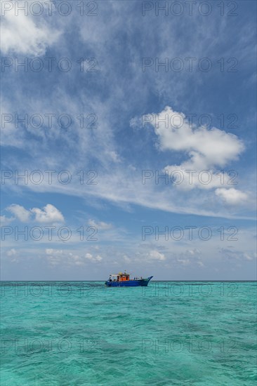Little boat in the turquoise waters of Agatti Island, Lakshadweep archipelago, Union territory of India