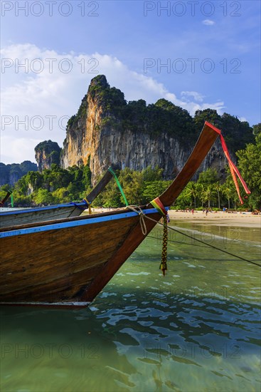 Longtail boat for transporting tourists, water taxi, taxi boat, ferry, ferry boat, fishing boat, wooden boat, boat, decorated, tradition, traditional, bay, sea, ocean, Andaman Sea, tropics, tropical, chalk cliffs, landscape, island, water, travel, tourism, paradisiacal, beach holiday, sun, sunny, holiday, dream trip, holiday paradise, paradise, coastal landscape, nature, idyllic, turquoise, Siam, exotic, travel photo, Krabi, Thailand, Asia