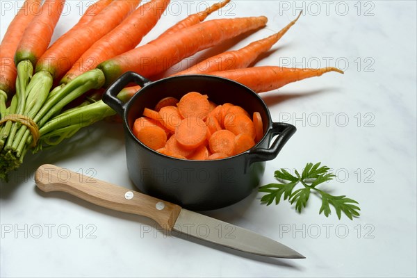 Sliced carrots in pot and bunch Carrots, Daucus carota, carrots