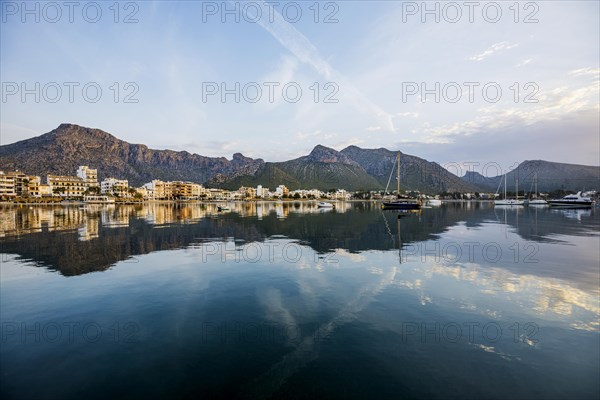 Village by the sea and mountains at sunrise, Port de Pollenca, Serra de Tramuntana, Majorca, Balearic Islands, Spain, Europe