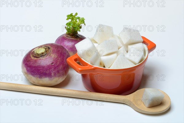 Purple turnip and split turnip in pot, Brassica rapa
