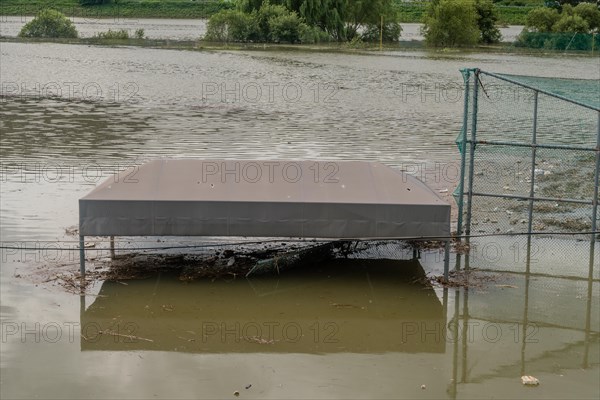 Top of benches submerged by flood water at baseball diamond in riverside park after torrential monsoon rains in Daejeon South Korea