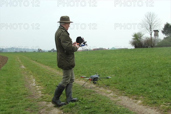 Hunter launches drone during a hare (Lepus europaeus) census, Lower Austria, Austria, Europe