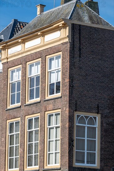 Side view of an old brick building with gabled roof and several windows, Middelburg, Zeeland, Netherlands