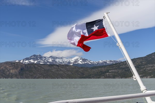 Boat trip, glacial lake, flag, Lago Grey, Torres del Paine National Park, Parque Nacional Torres del Paine, Cordillera del Paine, Towers of the Blue Sky, Region de Magallanes y de la Antartica Chilena, Ultima Esperanza province, UNESCO biosphere reserve, Patagonia, end of the world, Chile, South America