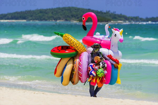 Merchant on the beach selling inflatable swimming aids, colourful, swimming, beach vendor, holiday, symbol, symbolic, rubber animals, inflatable, swimming figures, plastic, synthetic, summer, sun, fun, bathing, swimming, children's toy, bathing fun, pleasure, bathing holiday, summer holiday, neon colours, play, childhood, swimming ring, lifebuoy, water toy, Koh Samui, Thailand, Asia