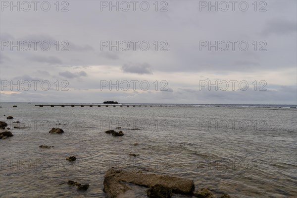 Seascape of the pacific ocean with a rocky shoreline taken in Guam on a cloudy day in Guam