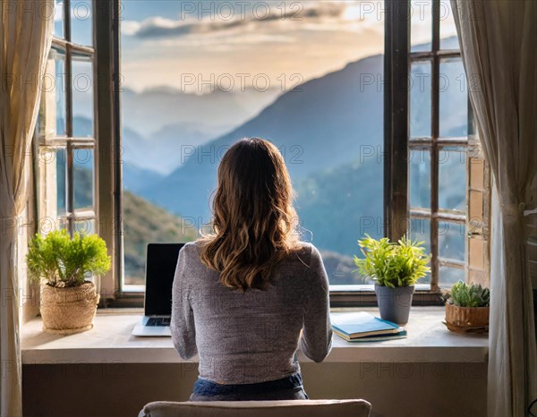 Woman looking out of a window at a mountain landscape, in front of her a laptop, AI generated, AI generated