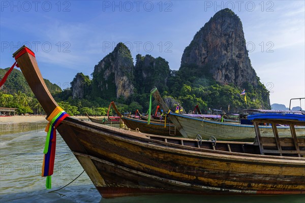 Longtail boat for transporting tourists, water taxi, taxi boat, ferry, ferry boat, fishing boat, wooden boat, boat, decorated, tradition, traditional, bay, sea, ocean, Andaman Sea, tropics, tropical, chalk cliffs, landscape, island, water, travel, tourism, paradisiacal, beach holiday, sun, sunny, holiday, dream trip, holiday paradise, paradise, coastal landscape, nature, idyllic, turquoise, Siam, exotic, travel photo, Krabi, Thailand, Asia