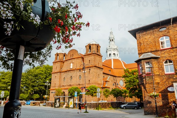 Panorama of Nikiszowiec brick architecture with flowers in the foreground in focus, Katowice, Poland, Europe