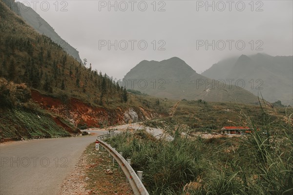 Cinematic foggy winding road to the karst mountains in Meo vac District, Ha giang Vietnam