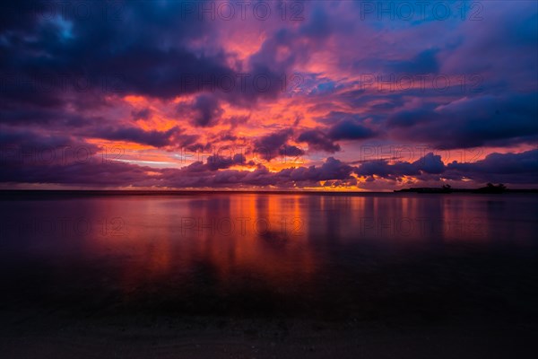 Beautiful sunset over ocean water taken from a beach in Guam