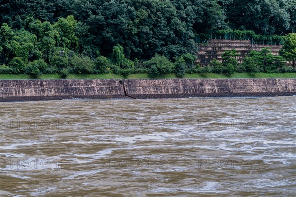 Water rushing rapidly down a river swelled my torrential monsoon rainfall in Daejeon South Korea