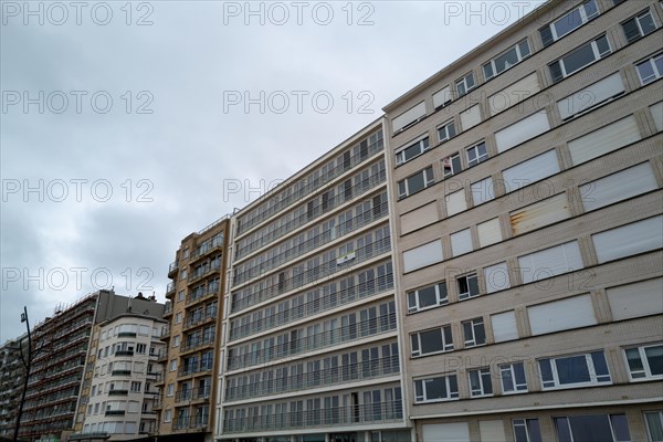 Row of large residential buildings with many windows and balconies on a cloudy day, Blankenberge, Flanders, Belgium, Europe
