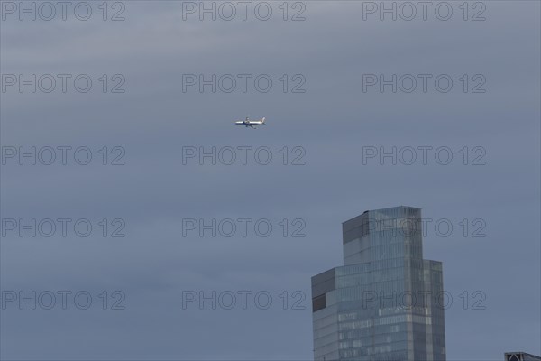 Aircraft of British airways in flight over a city skyscraper building, London, England, United Kingdom, Europe