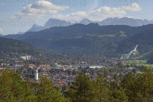 Overview of Garmisch-Partenkirchen with Karwendel mountains and forest in autumn, hiking trail Kramerplateauweg, Garmisch-Partenkirchen, Upper Bavaria, Bavaria, Germany, Europe