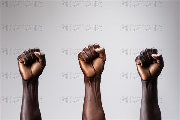 Raised fists of black african american men in front of gray background. KI generiert, generiert AI generated