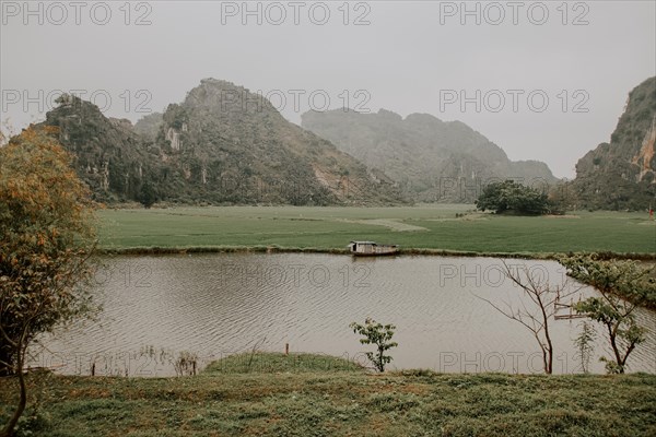 Cinematic scenery of a foggy morning in Yen Thang Lake in Ninh Binh Vietnam