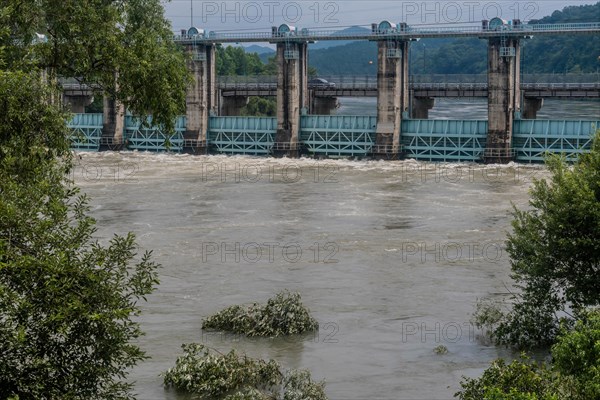 Dam on a river experiencing heavy flood waters and strong currents, in South Korea