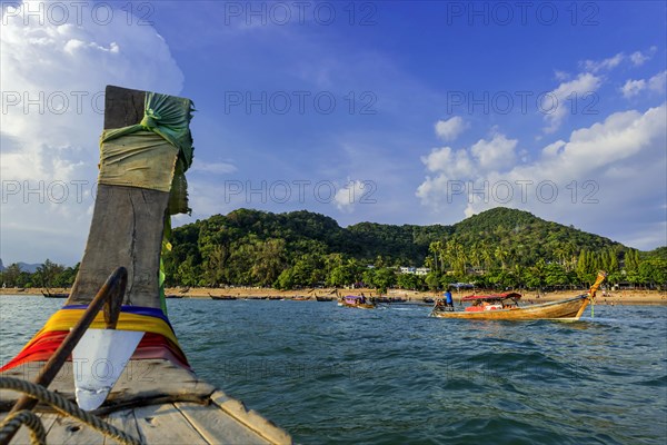 Longtail boat for transporting tourists, water taxi, taxi boat, fishing boat, wooden boat, boat, decorated, tradition, traditional, bay, sea, ocean, Andaman Sea, tropics, tropical, island, water, travel, tourism, paradise, beach holiday, sun, sunny, holiday, dream trip, holiday paradise, paradise, coastal landscape, nature, idyllic, turquoise, Siam, exotic, travel photo, Krabi, Thailand, Asia