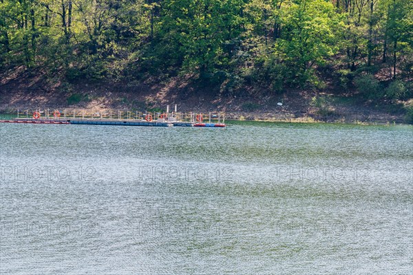 Landscape of a river and trees on the riverbank and a boat dock floating in the middle of the river in South Korea