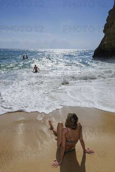 Young woman on the beach on summer holiday, sun, summer, summer holiday, holiday happiness, tourism, travel, symbolic, symbol, beach holiday, bathing holiday, swimming, sea, Atlantic Ocean, waves, surf, ocean, Algarve, Portugal, Europe