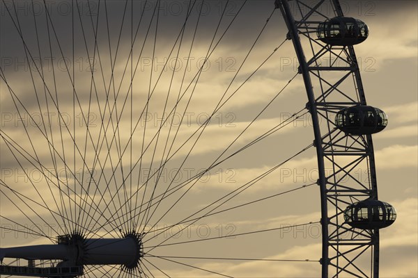London Eye or Millennium Wheel tourist observation wheel close up of pods and spokes at sunset, City of London, England, United Kingdom, Europe