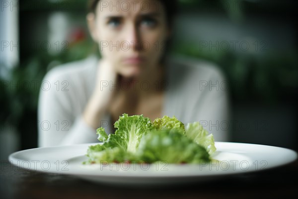 Plate with salad and frustrated hungry woman on diet in blurry background. KI generiert, generiert AI generated