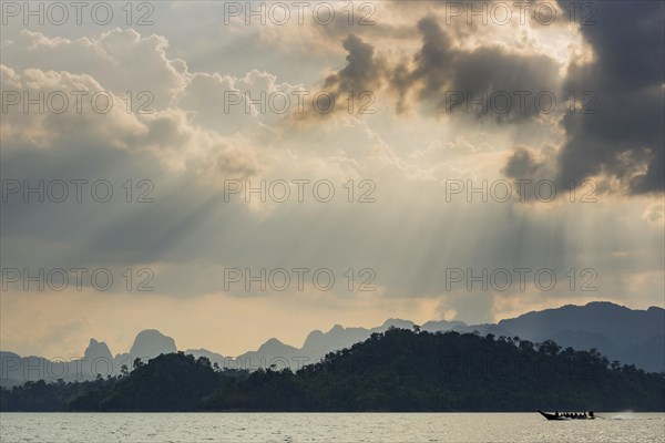 Limestone rocks in the evening light in Cheow Lan Lake in Khao Sok National Park, evening, sunset, light mood, nature, travel, holiday, lake, reservoir, landscape, rock, rock formation, attraction, water, tourism, boat trip, excursion, boat trip, nature reserve, travel photo, Thailand, Asia