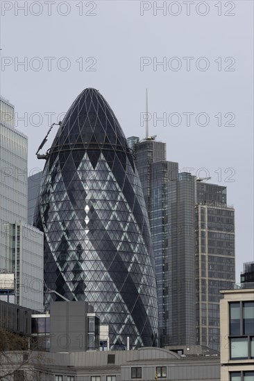 The Gherkin skyscraper building and nearby high rise office building, City of London, England, United Kingdom, Europe