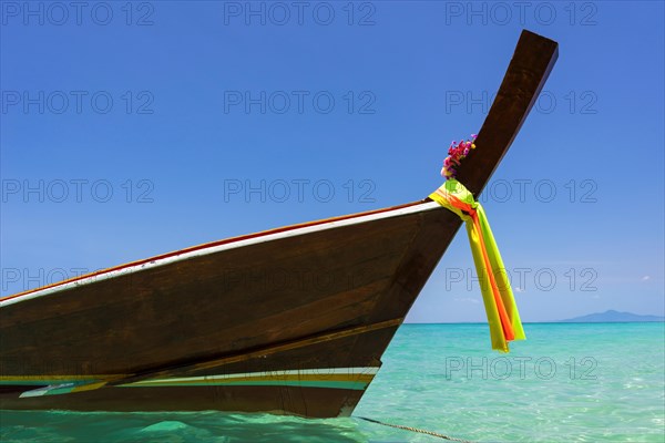 Longtail boat, fishing boat, wooden boat, boat, decorated, tradition, traditional, faith, cloth, colourful, bay, sea, ocean, Andaman Sea, tropics, tropical, island, water, beach, beach holiday, Caribbean, environment, clear, clean, peaceful, picturesque, sea level, climate, travel, tourism, paradisiacal, beach holiday, sun, sunny, holiday, dream trip, holiday paradise, paradise, coastal landscape, nature, idyllic, turquoise, Siam, exotic, travel photo, sandy beach, seascape, Phi Phi Island, Thailand, Asia