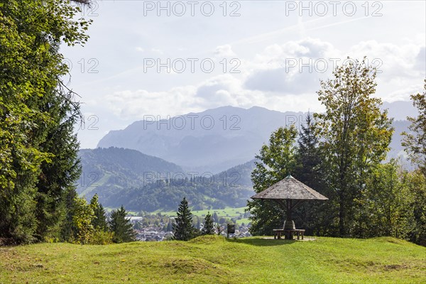 Wetterstein mountains with forest and shelter with benches, in autumn, hiking trail Kramerplateauweg, Garmisch-Partenkirchen, Upper Bavaria, Bavaria, Germany, Europe