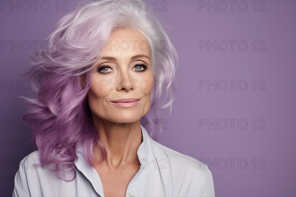 Middle-aged or elderly woman with bold punkish purple dyed hair in front of studio background. KI generiert, generiert AI generated