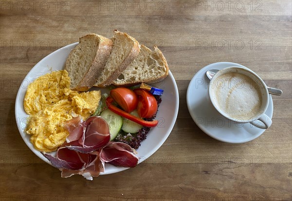 Food, breakfast, scrambled eggs, bread, South Tyrolean ham, tomatoes, gherkins, cappuccino, Stuttgart, Baden-Wuerttemberg, Germany, Europe