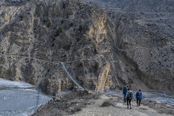 Tourists hiking a huge hanging bridge, Kingdom of Mustang, Nepal, Asia
