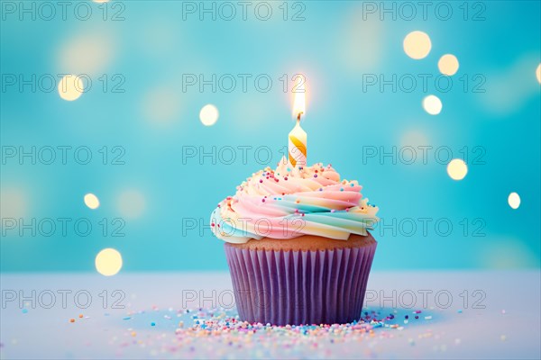 Single cupcake with rainbow pastel colored frosting and single birthday candle on blue background. KI generiert, generiert AI generated