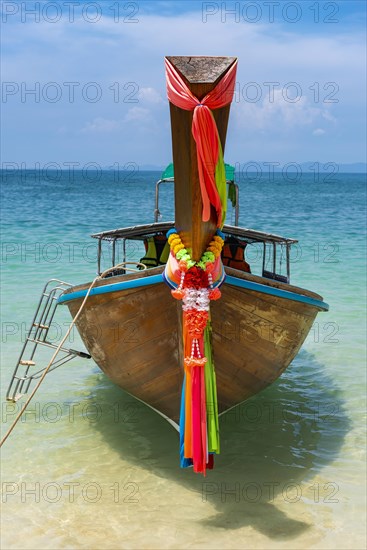 Longtail boat, fishing boat, wooden boat, boat, decorated, tradition, traditional, faith, cloth, colourful, bay, sea, ocean, Andaman Sea, tropics, tropical, island, water, beach, beach holiday, Caribbean, environment, clear, clean, peaceful, picturesque, sea level, climate, travel, tourism, paradisiacal, beach holiday, sun, sunny, holiday, dream trip, holiday paradise, paradise, coastal landscape, nature, idyllic, turquoise, Siam, exotic, travel photo, sandy beach, seascape, Phi Phi Island, Thailand, Asia