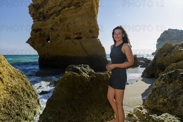 Young woman on summer holiday, emotion, rock, distance, view, sun, summer, summer holiday, holiday happiness, tourism, travel, symbolic, symbol, beach holiday, unadorned, natural, naturalness, authentic, self-confident, beach holiday, Algarve, Portugal, Europe