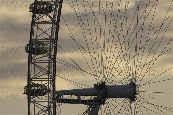 London Eye or Millennium Wheel tourist observation wheel close up of pods and spokes at sunset, City of London, England, United Kingdom, Europe