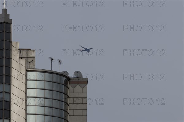 Airbus A319-100 aircraft of British airways in flight over a city skyscraper building, London, England, United Kingdom, Europe
