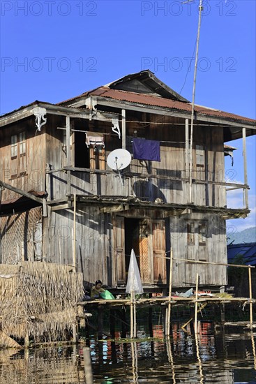 Old weathered stilt house with satellite dish, Inle Lake, Myanmar, Asia