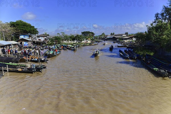View of a busy riverbank with market activities and boats, Pindaya, Inle Lake, Myanmar, Asia