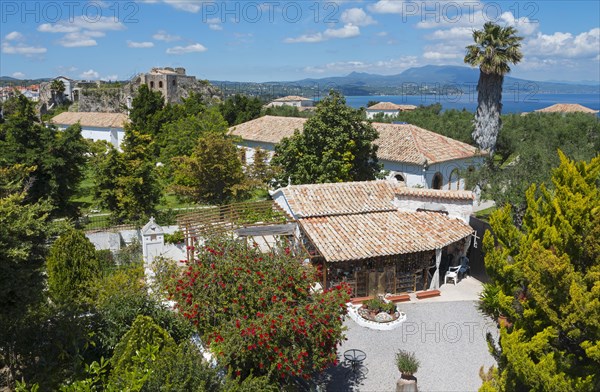 Monastery with buildings with terracotta roofs, sea view and a castle in the background, on the left the viewpoint, view of the courtyard of the Holy Monastery of Timi Prodromos, Byzantine fortress, nunnery, Koroni, Pylos-Nestor, Messinia, Peloponnese, Greece, Europe