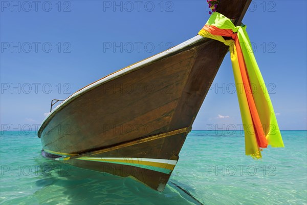 Longtail boat, fishing boat, wooden boat, boat, decorated, tradition, traditional, faith, cloth, colourful, bay, sea, ocean, Andaman Sea, tropics, tropical, island, water, beach, beach holiday, Caribbean, environment, clear, clean, peaceful, picturesque, sea level, climate, travel, tourism, paradisiacal, beach holiday, sun, sunny, holiday, dream trip, holiday paradise, paradise, coastal landscape, nature, idyllic, turquoise, Siam, exotic, travel photo, sandy beach, seascape, Phi Phi Island, Thailand, Asia